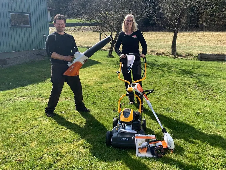 Man och kvinna visar trädgårdsverktyg